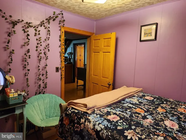 a bedroom with a bed and a mirror