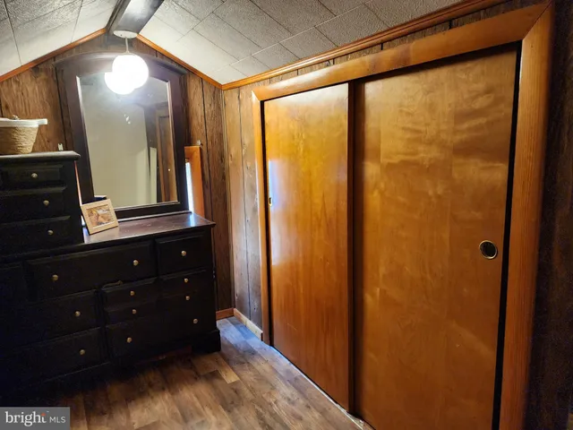 a bedroom with two beds and wooden floor