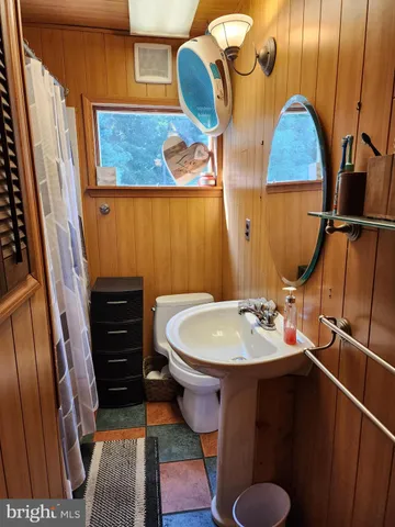 a bathroom with a sink toilet and mirror