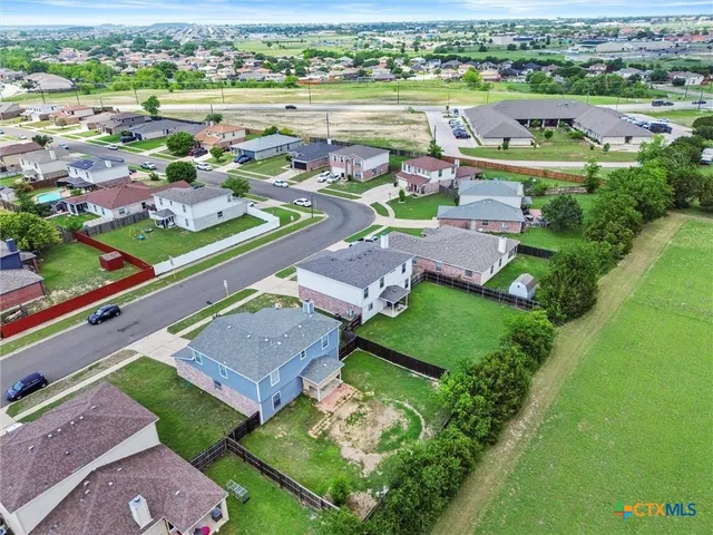 an aerial view of a house with outdoor space and lake view