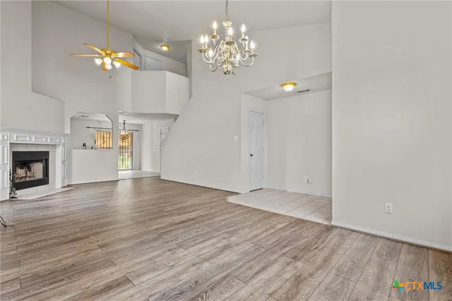 a view of a chandelier in a room with a chandelier and fireplace