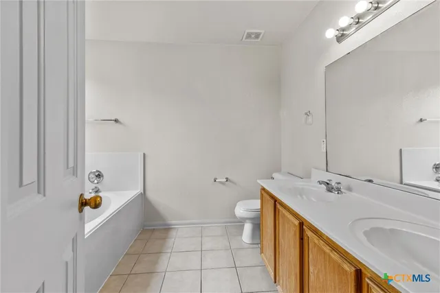 a bathroom with a sink a tub and a mirror