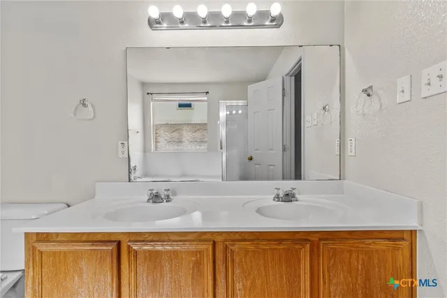 a bathroom with a granite countertop sink a mirror and a