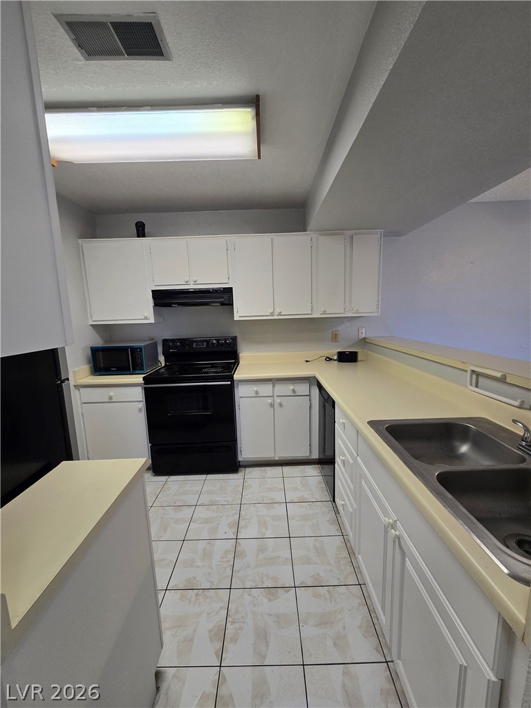 6750 Del Rey Avenue, Unit 133 Las Vegas, NV 89146 - Photo 10 of 34 Functional kitchen with ample cabinet space, durable countertops, and an essential appliance suite.