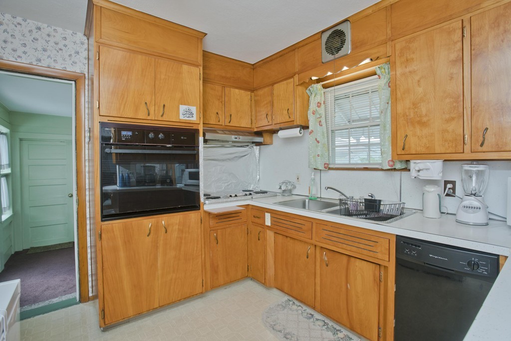 32 Rathbun Street Springfield, MA 01104 - Photo 12 of 26 a kitchen with stainless steel appliances a sink stove and cabinets