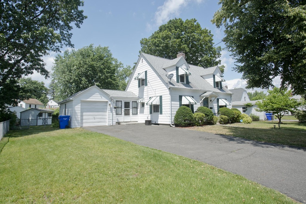 32 Rathbun Street Springfield, MA 01104 - Photo 3 of 26 a front view of a house with a yard and garage