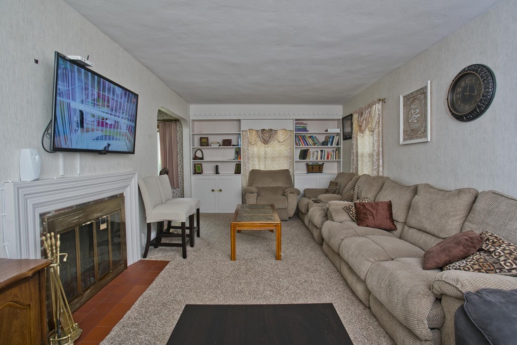 32 Rathbun Street Springfield, MA 01104 - Photo 6 of 26 a living room with furniture a fireplace and a large window