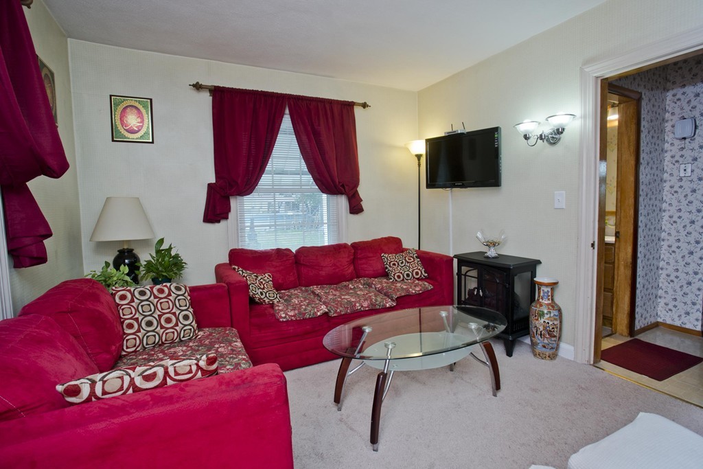 32 Rathbun Street Springfield, MA 01104 - Photo 8 of 26 a living room with furniture and a flat screen tv