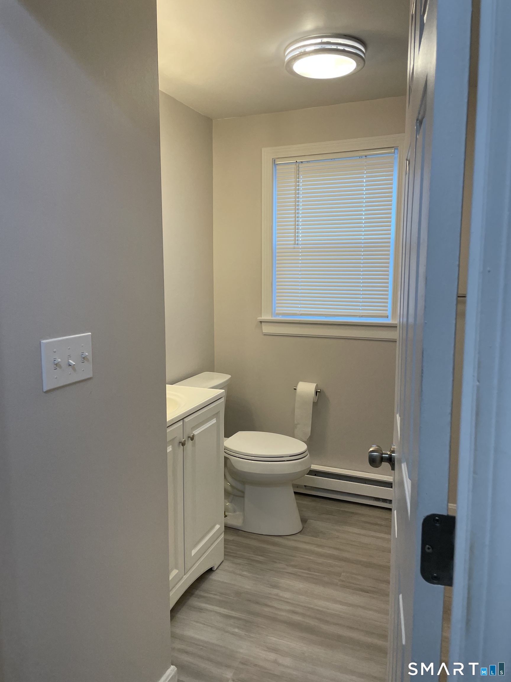 64 Deshon Street New London, CT 06320 - Photo 5 of 8 a white toilet sitting next to a bathroom sink