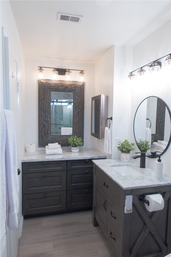 696 West Lori Ann Avenue Azusa, CA 91702 - Photo 16 of 22 a bathroom with a granite countertop double vanity and a mirror
