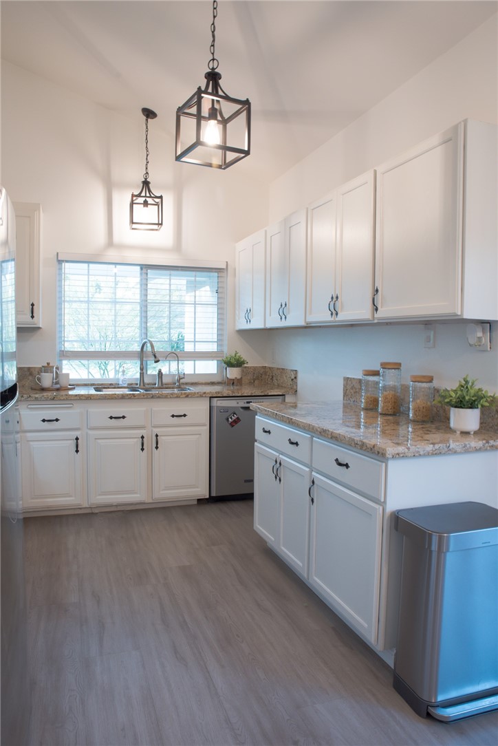 696 West Lori Ann Avenue Azusa, CA 91702 - Photo 8 of 22 a kitchen with granite countertop white cabinets a sink a window and appliances