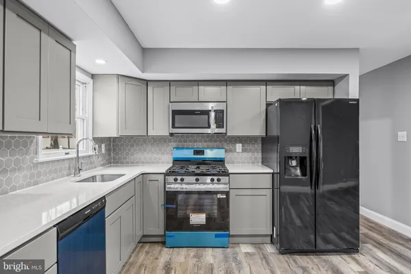 a kitchen with a refrigerator sink and stove