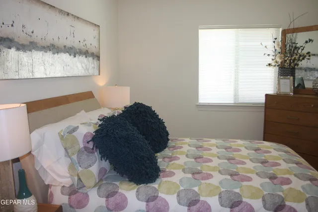 a bedroom with a bed and a painting on the wall