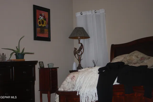 a bedroom with a bed and a lamp on table