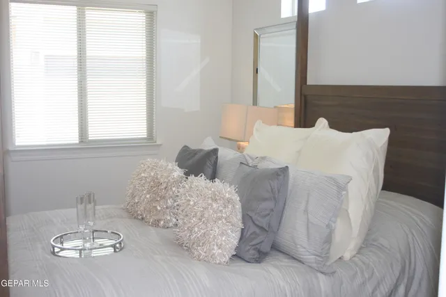 a bed sitting in a bedroom next to a window