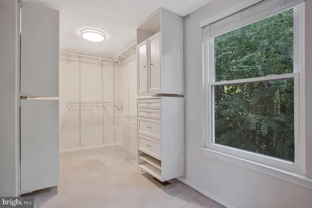 a view of cabinets and window in a room