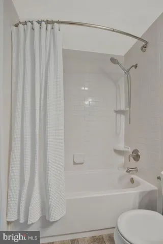 a bathroom with a shower curtain and a toilet