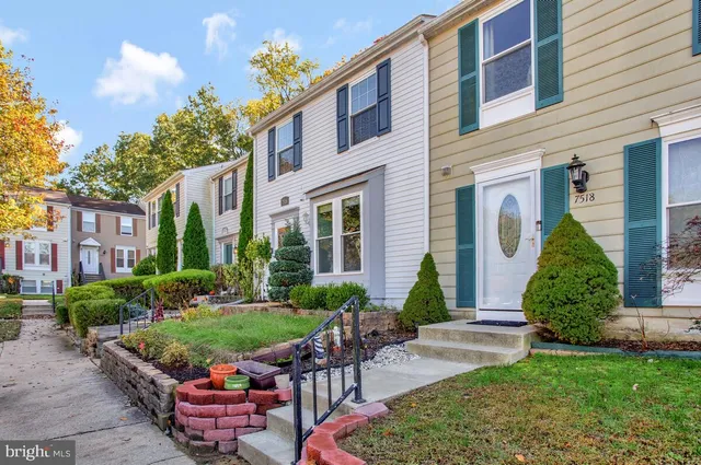 a car parked in front of a white house