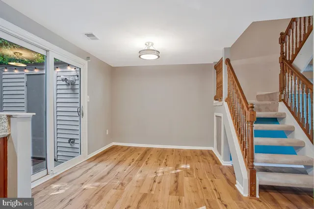 a view of a room with wooden floor and stairs