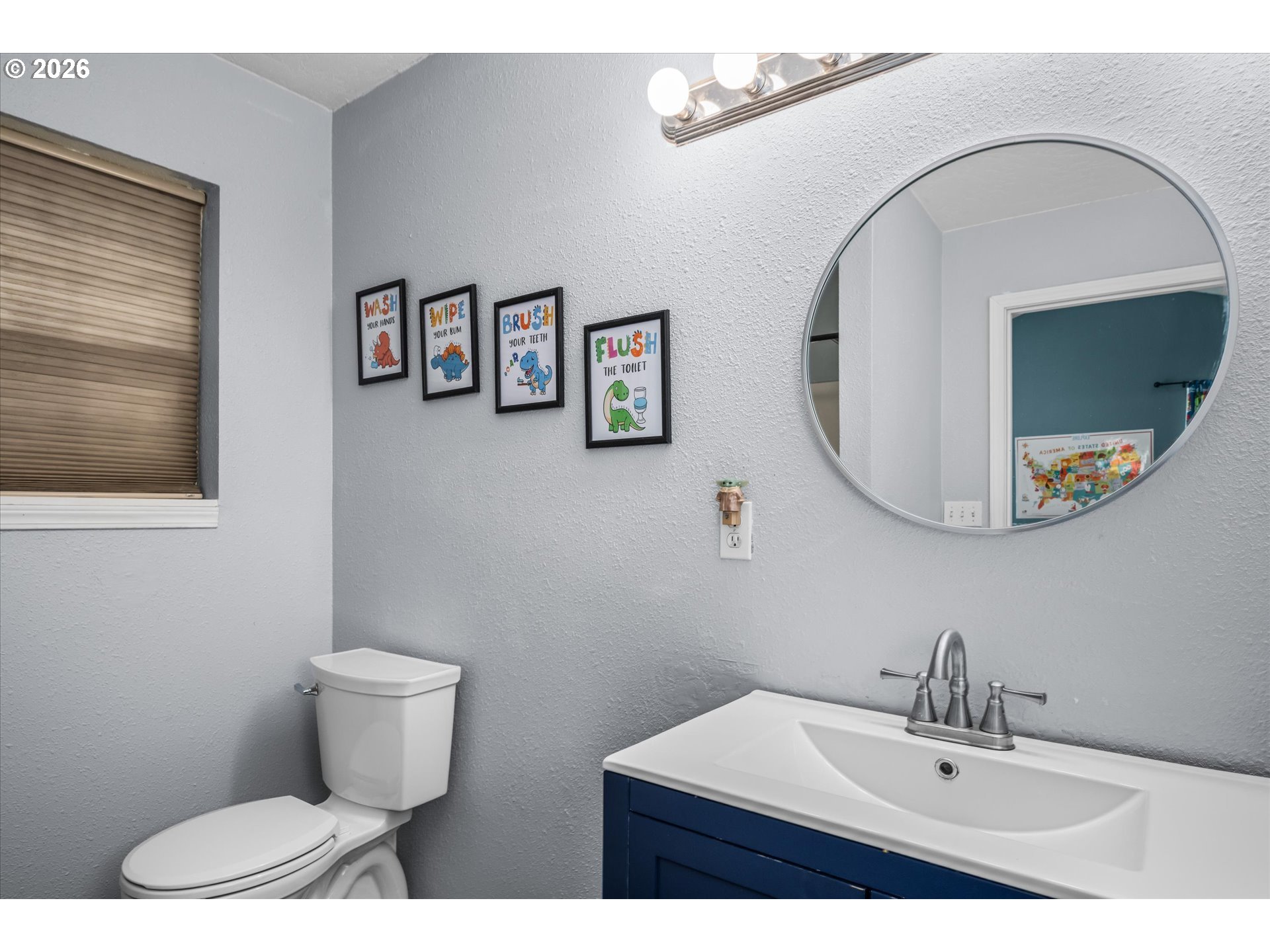 91051 Leashore Drive Vida, OR 97488 - Photo 26 of 36 a bathroom with a toilet a sink and mirror