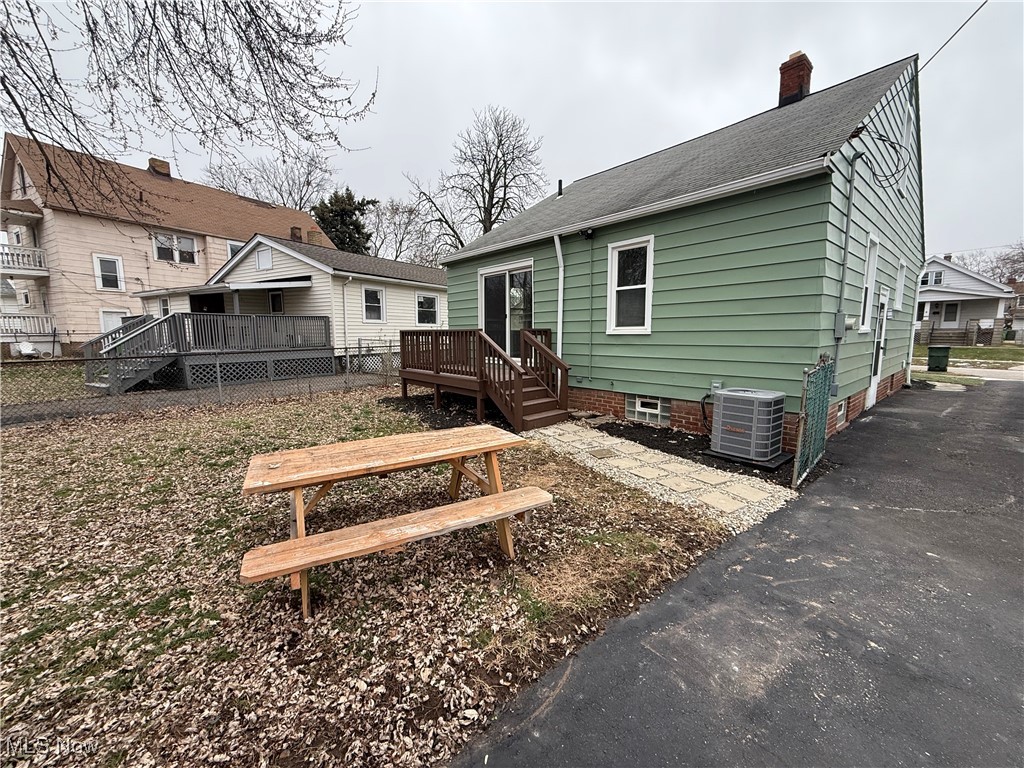4658 Burleigh Road Cleveland, OH 44125 - Photo 24 of 24 Back of house featuring a deck, a chimney, and roof with shingles