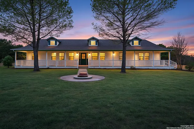 a front view of house with yard and green space