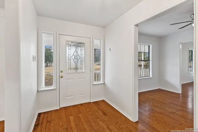 a kitchen with granite countertop a sink stove and refrigerator