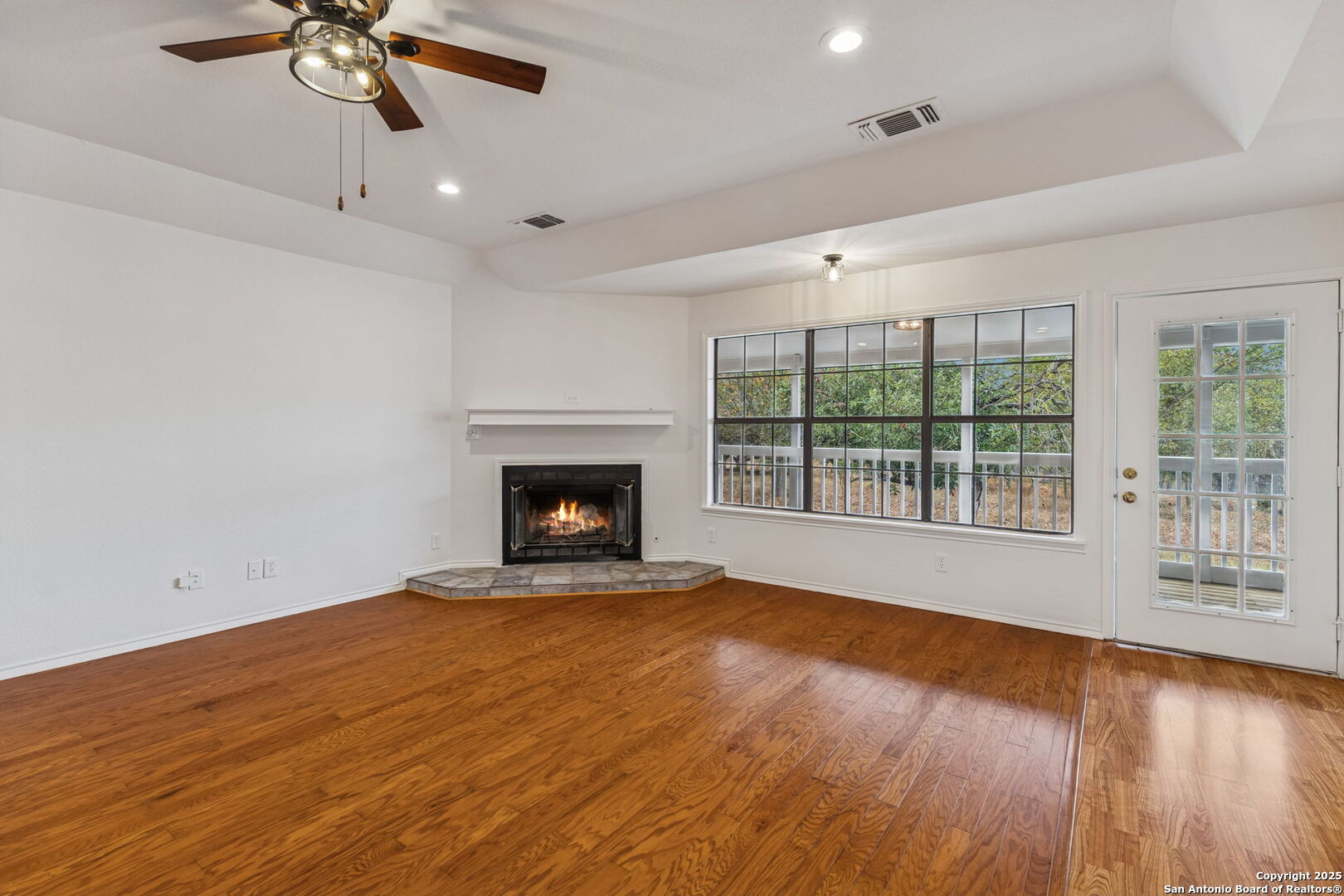 247 Center Point Drive East Center Point, TX 78010 - Photo 16 of 87 a view of an empty room with wooden floor fireplace and a window