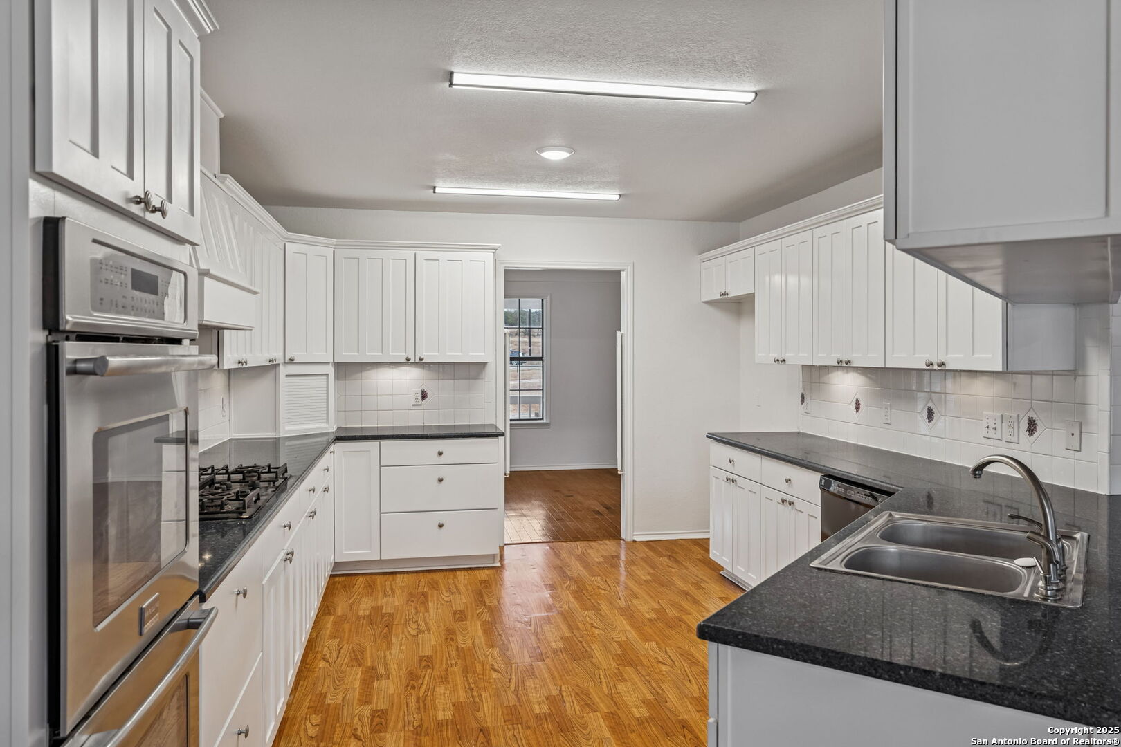 247 Center Point Drive East Center Point, TX 78010 - Photo 19 of 87 a kitchen with granite countertop a sink stove and refrigerator