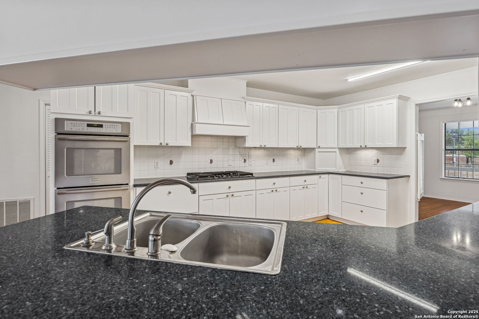 247 Center Point Drive East Center Point, TX 78010 - Photo 20 of 87 a kitchen with kitchen island granite countertop a sink a stove and white cabinets