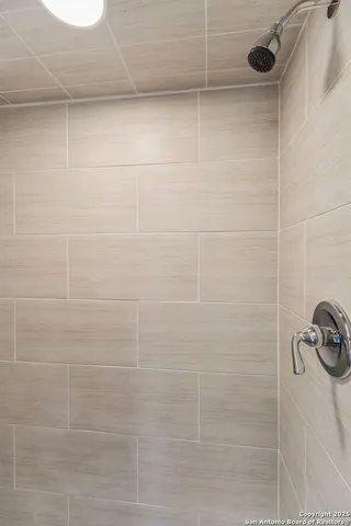 a view of an empty room with a ceiling fan