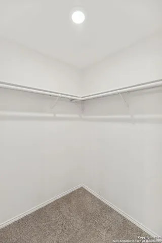 a spacious bathroom with a double vanity sink a mirror and a bathtub