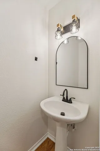 a view of a hallway with wooden floor and closet