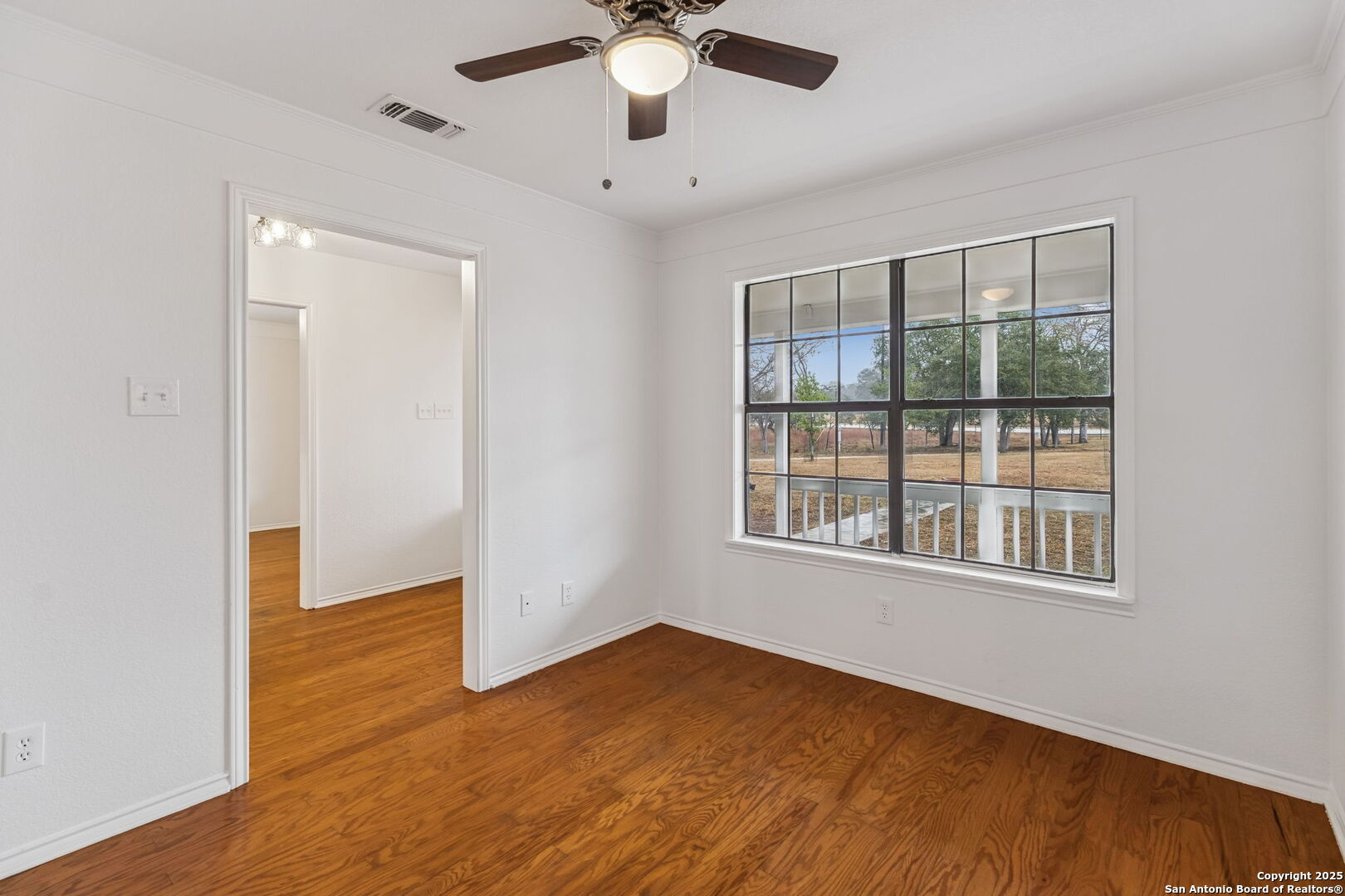 247 Center Point Drive East Center Point, TX 78010 - Photo 39 of 87 a view of an empty room with wooden floor and a window
