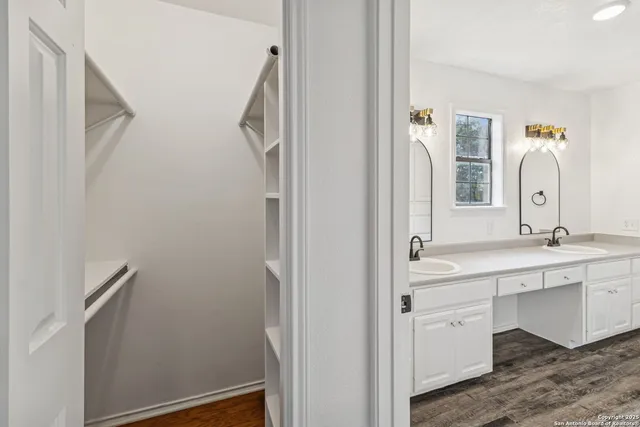 a bathroom with a sink and mirror with window