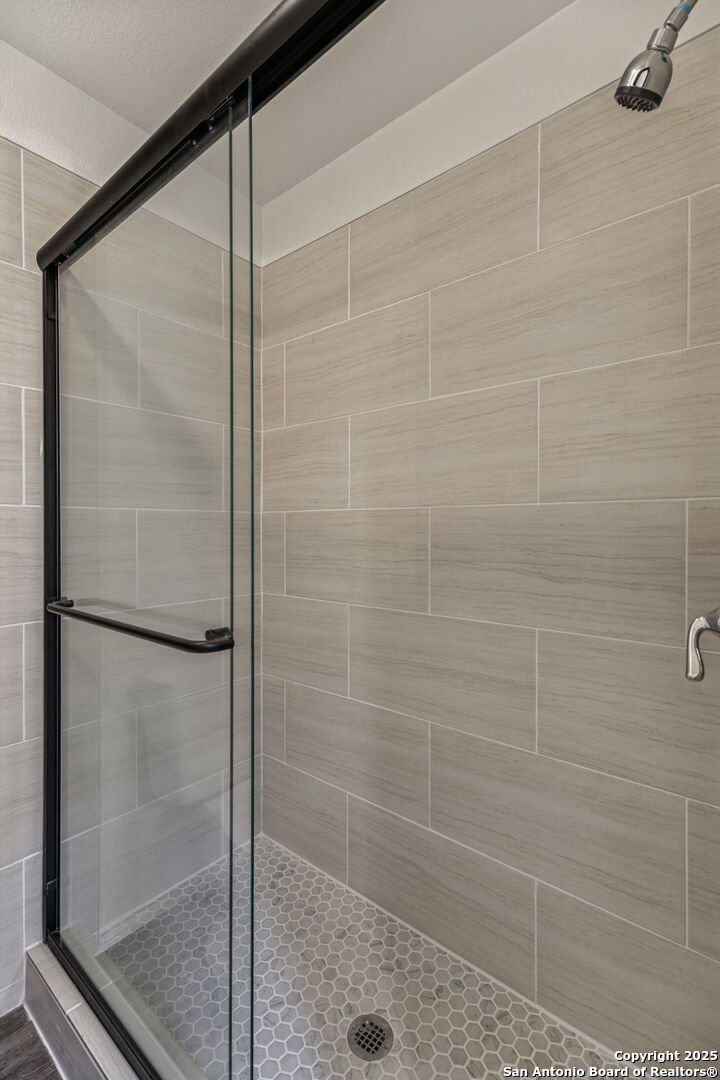 247 Center Point Drive East Center Point, TX 78010 - Photo 47 of 87 a bathroom with a glass shower door