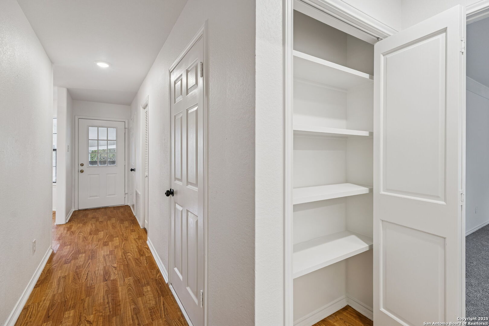 247 Center Point Drive East Center Point, TX 78010 - Photo 56 of 87 a view of a hallway with wooden floor and a bathroom