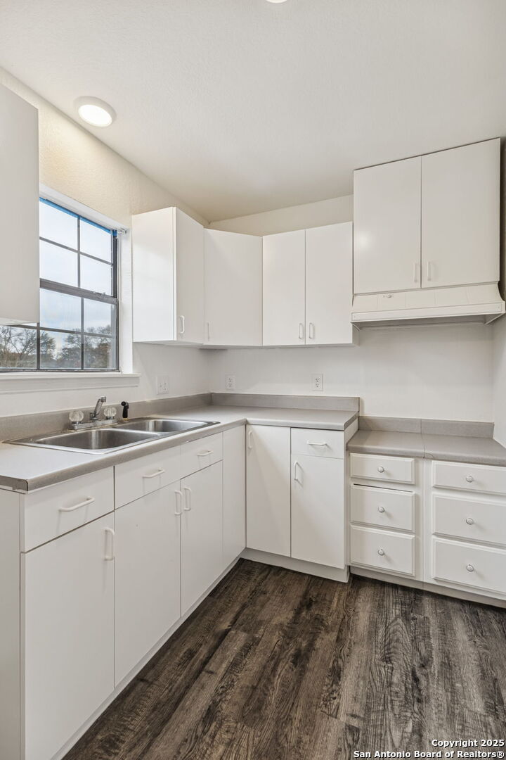 247 Center Point Drive East Center Point, TX 78010 - Photo 62 of 87 a kitchen with granite countertop white cabinets and white appliances
