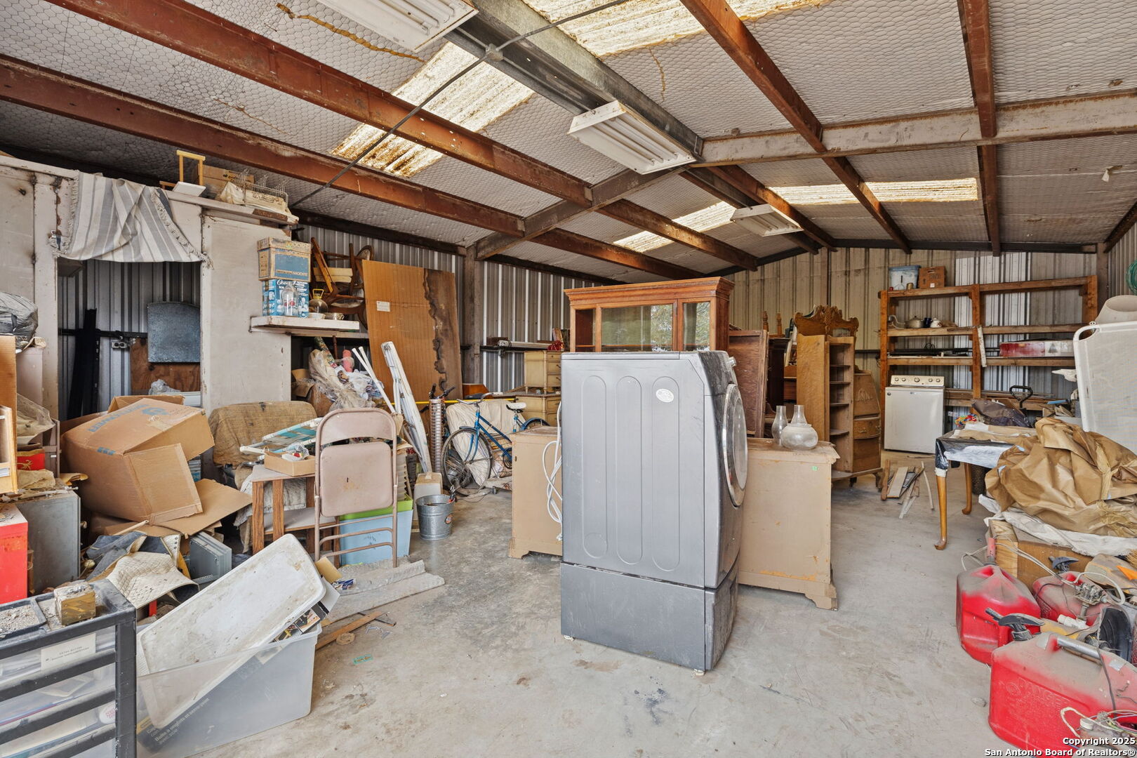 247 Center Point Drive East Center Point, TX 78010 - Photo 77 of 87 a view of a storage room with water heater and racks