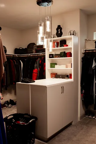 a dining room with a sink a rug and a mirror