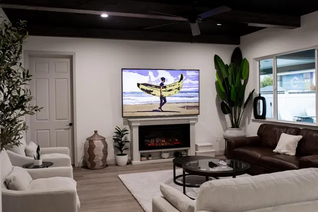 a living room with furniture a fireplace and a potted plant