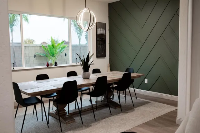 a view of a dining room with furniture and a potted plant