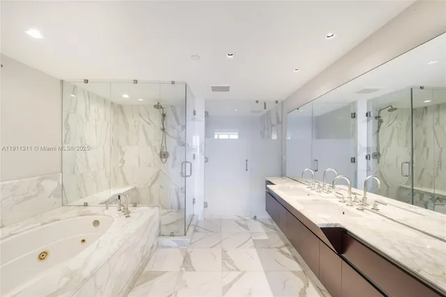 a large bathroom with a tub sink shower and mirror