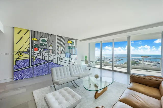 a living room with furniture and a floor to ceiling window