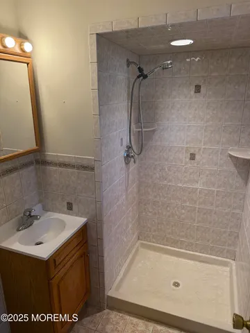a view of a livingroom with wooden floor and a sink
