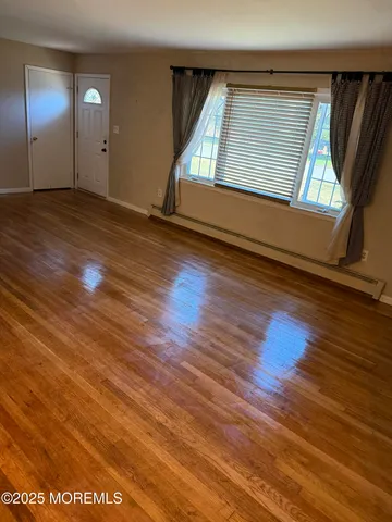 a view of a livingroom with wooden floor