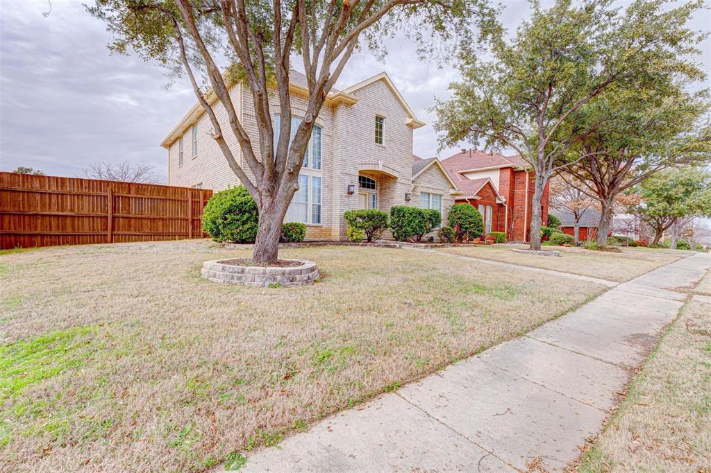 3945 Luke Lane Carrollton, TX 75007 - Photo 1 of 1 a front view of a house with a yard and garage