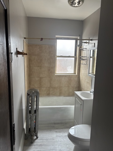 1248 West 83rd Street, Unit 1 Chicago, IL 60620 - Photo 4 of 7 a bathroom with a sink a toilet a window and shower