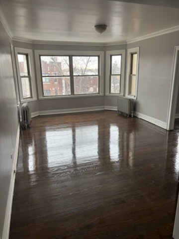 1248 West 83rd Street, Unit 1 Chicago, IL 60620 - Photo 6 of 7 a view of empty room with wooden floor and fan