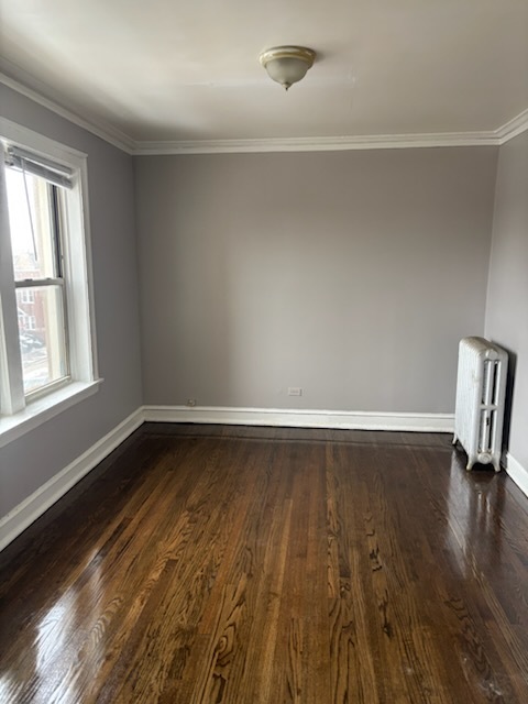 1248 West 83rd Street, Unit 1 Chicago, IL 60620 - Photo 7 of 7 a view of an empty room with wooden floor and a window